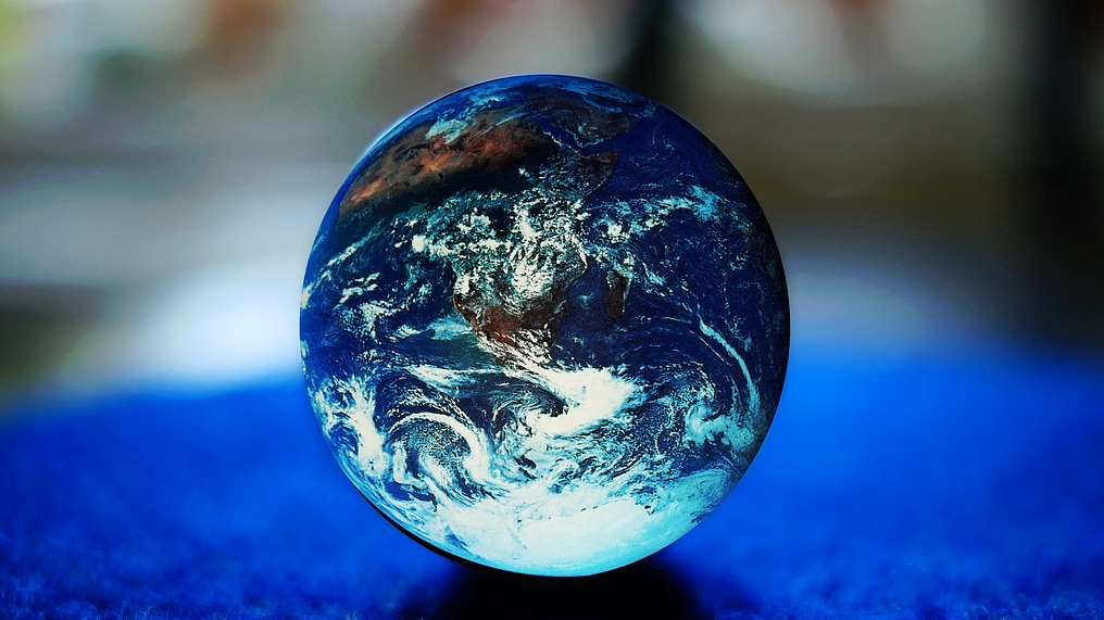 Earth resting on blue surface with blurry background